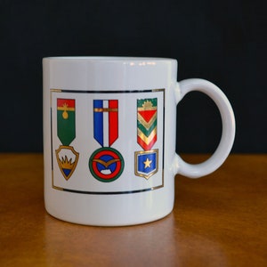 Vintage Europe - European Souvenir Ceramic Mug Depicting Three Medals / Insignias (2643B)