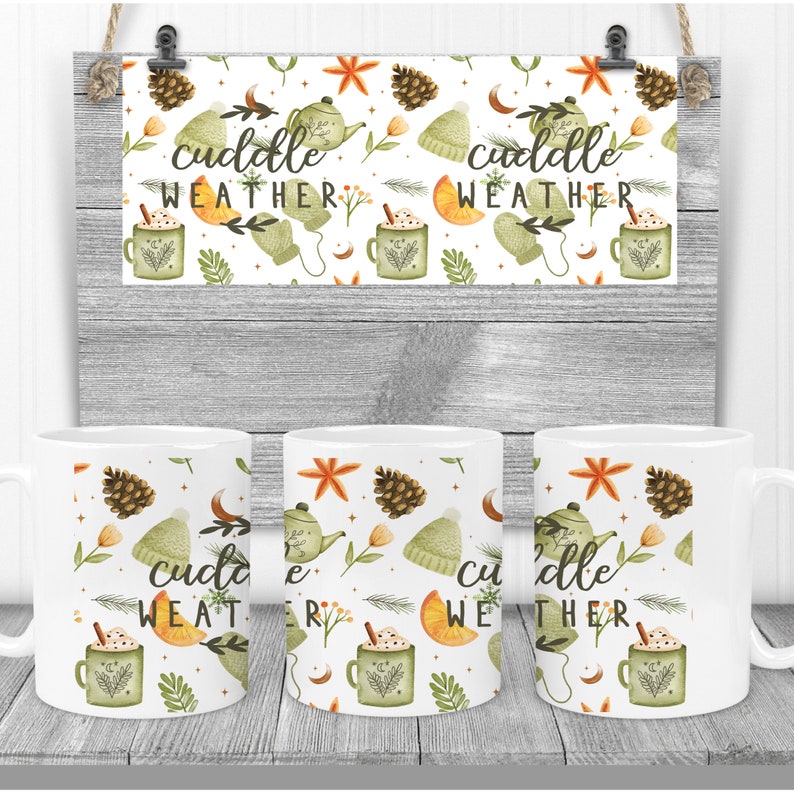 May include: Three white mugs with a wintery design featuring a teapot, pine cones, mittens, and the text "cuddle weather".