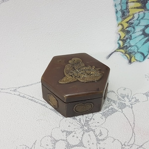Vintage hexagonal pill or trinket box, small vintage brass and copper hinged lid box decorated with ornate panels
