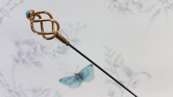 Vintage gold tone hat pin with turquoise glass sto
