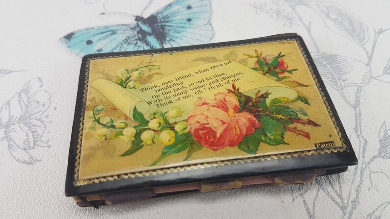 May include: A vintage black and gold keepsake box with a floral design and a scroll with the text "Think, dear friend, when thou art pondering On the past, so sad to thee, With its many scenes and changes, Think of me, th! think of me" and the word "Patent".
