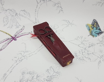 Estuche de costura de cuero rojo antiguo con tijeras y dedal