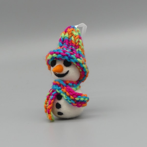 Gefilzter Schneemann mit gestrickter Mütze und Schal