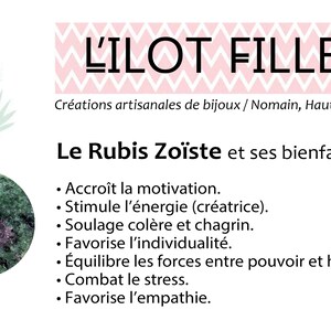 May include: An image featuring a pink flamingo illustration, a green and purple stone, and text in French. The text includes "L'ILOT FILLES" and details about "Le Rubis Zo&iuml;ste" and its benefits, such as motivation and stress relief.