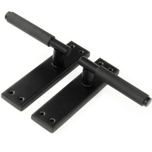 May include: Two black door handles with a rectangular base and a long, textured handle. The handles are made of metal and have a matte finish.