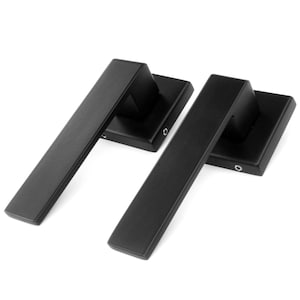 May include: Two black door handles with square backplates. The handles are made of metal and have a modern design.