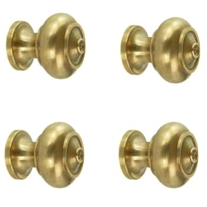 May include: Four brass cabinet knobs. Each knob has a rounded body with a decorative ring and a circular base. The knobs are a warm, golden colour, suggesting a vintage or antique aesthetic. Ideal for furniture restoration or new builds.