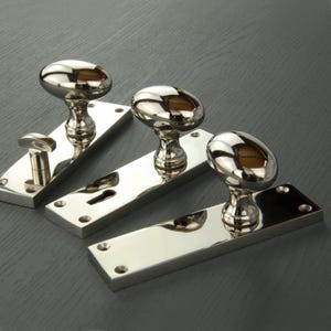New York Door Knobs Oval Round Handles on Long Backplate Polished Nickel