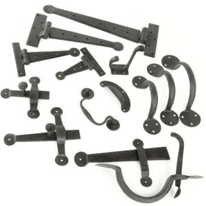 May include: A selection of black wrought iron hardware, including hinges, handles, latches, and a hook. The hardware pieces vary in size and shape, with a rustic, antique aesthetic. Suitable for doors, gates, or cabinets.