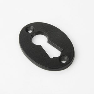 May include: Black oval keyhole cover with two small screws.