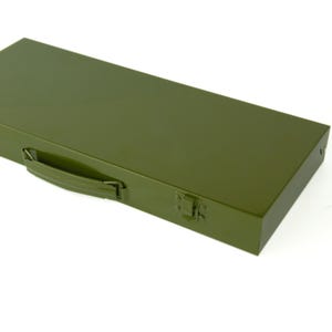May include: An olive green metal toolbox with a handle and a latch. The rectangular box has a smooth, reflective surface. The handle is curved and the latch is on the right side of the box.
