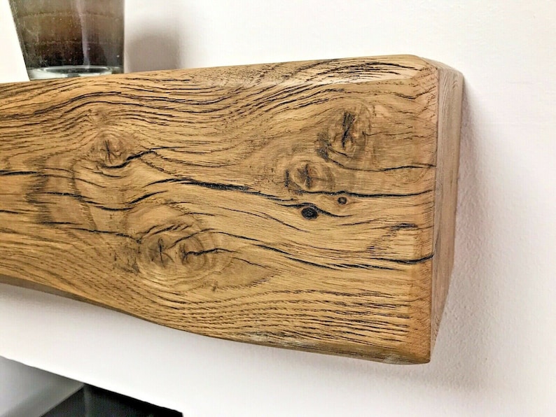 May include: A rustic wooden shelf with a natural wood finish and a slightly curved edge. The shelf has a knotty grain pattern and a warm brown color.