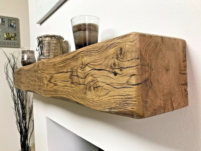 May include: A rustic wooden mantel shelf with a natural wood finish. The shelf is made from reclaimed wood and has a unique, weathered look. It is perfect for displaying decorative items or showcasing your favorite photos.