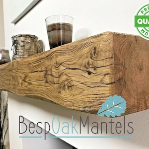 May include: A rustic wooden shelf with a natural wood finish. The shelf is mounted on a white wall and has a few items on it, including a glass jar, a wicker basket, and a glass vase. The shelf is labeled "Bespoak Mantels" and has a "Premium Quality" sticker on the right side.