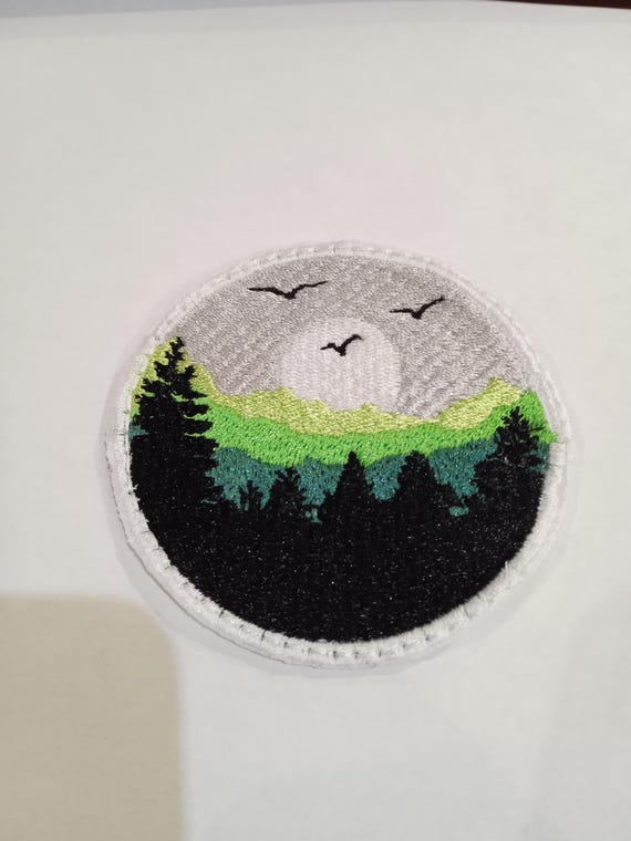 round embroidered forest badge