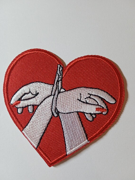 embroidered iron-on patch with heart and tied hands