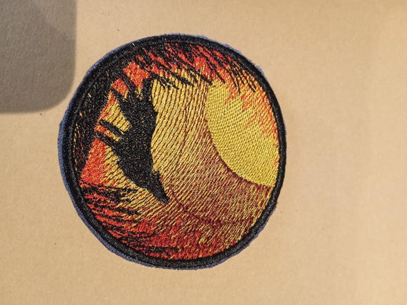 round embroidered wolf badge