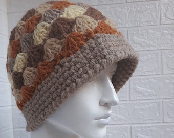 Women's bucket hat crocheted from warm pink and gray melange yarn and acrylic wool for autumn and winter.
