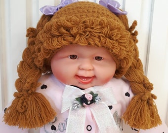 Children's knitted hat - wig for a photo shoot, brown, with bows.