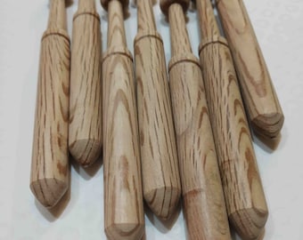 May include: A set of eight wooden knitting needles with a pointed tip and a rounded top. The needles are made of light brown wood with dark brown streaks.