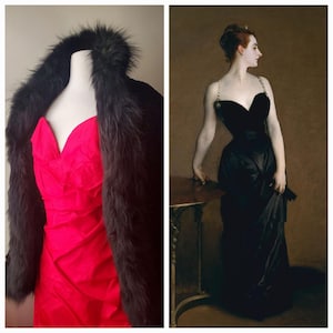 May include: A bright red dress with a V-neck is displayed on a mannequin, paired with a dark fur wrap. Next to it, a portrait shows a woman in a black evening gown, her posture elegant, against a dark background.