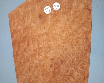 May include: Three pieces of wood veneer with a burl pattern. The veneer is a light brown color with dark brown swirls. The veneer is labeled with the text "CT 662" and "17 x 26 10".