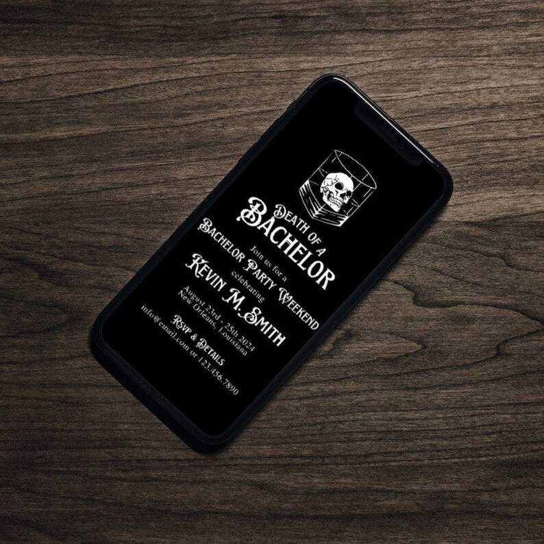 May include: A black smartphone displays a bachelor party invitation. The invitation features the text "Death of a Bachelor" with a skull graphic, and details for Kevin M. Smith's party in New Orleans, August 23rd-25th, 2024.