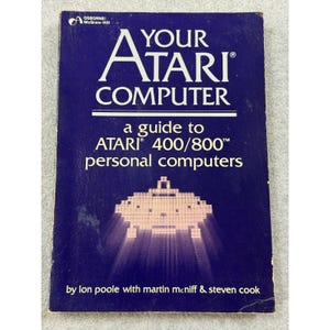 May include: A dark blue paperback book titled Your Atari Computer, a guide to Atari 400/800 personal computers by Lon Poole with Martin McNiff and Steven Cook. The cover features a white pixelated graphic of a spaceship and the Osborne/McGraw-Hill logo.