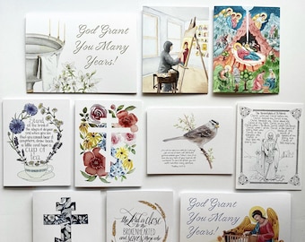 May include: A selection of watercolour art cards with religious themes. The cards show scenes like a nativity, a bird on a branch, floral crosses, and inspirational quotes. The colour palette includes blues, reds, and greens.