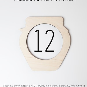 May include: Wooden milestone marker shaped like a jar with the number 12 in the center. The marker is made of 1/4 inch Baltic birch plywood and is sanded and ready to paint.