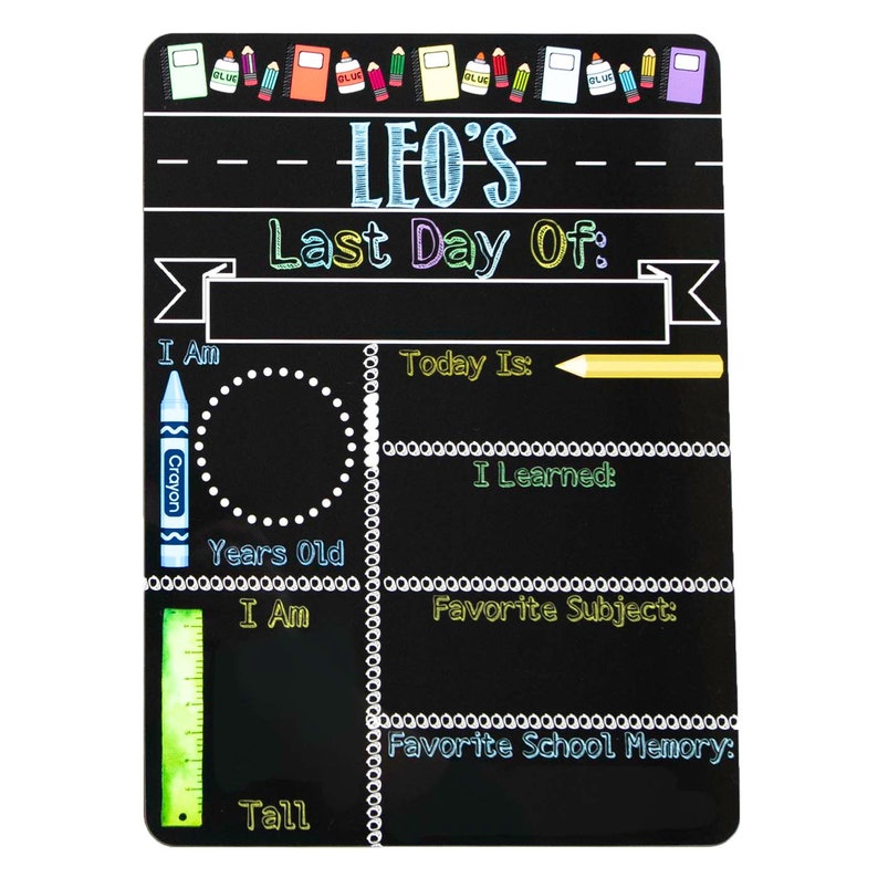 May include: Black chalkboard sign with the text "LEO'S Last Day Of:" and sections for writing about the student's age, height, favorite subject, and favorite school memory. The sign is decorated with colorful crayons, pencils, and rulers.