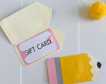 May include: A gift card holder shaped like a pencil, with a yellow body, pink eraser, and gray band. The gift card inside reads "GIFT CARD". The image also includes an open envelope and text that reads "SVG • DXF • PNG • JPG".