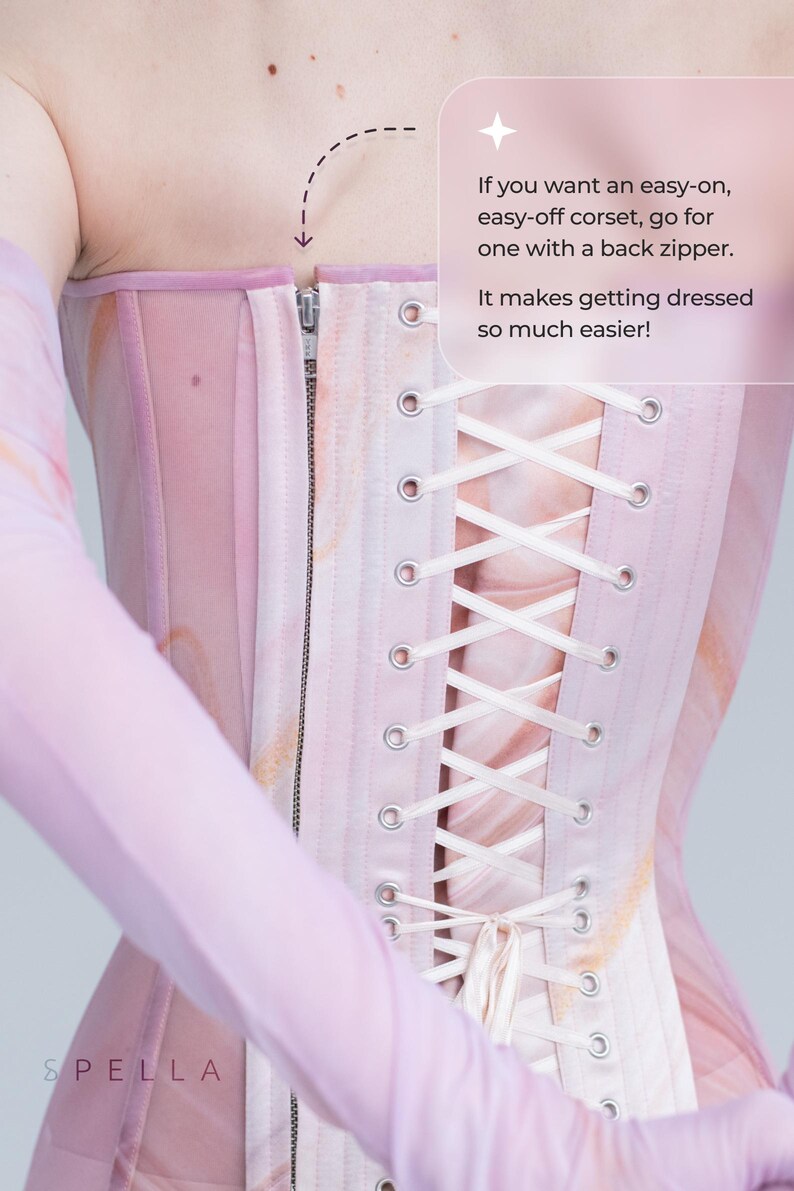 May include: A pink corset with a back zipper and white lacing. The text "If you want an easy-on, easy-off corset, go for one with a back zipper. It makes getting dressed so much easier!" is written on the right side of the image.