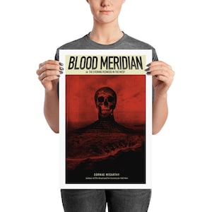 May include: A poster featuring a red and black illustration of a skull with a red background. The text on the poster reads "Blood Meridian or The Evening Redness in the West" and "Cormac McCarthy, Author of The Road and No Country for Old Men."