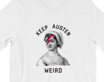 May include: White t-shirt with a black and white image of Jane Austen with a lightning bolt over her eye. The text "Keep Austen Weird" is printed on the shirt.