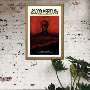 May include: A framed poster with a red background and a black skull in the center. The poster is titled "Blood Meridian" and features the text "Or The Evening Redness In The West" and "Cormac McCarthy".