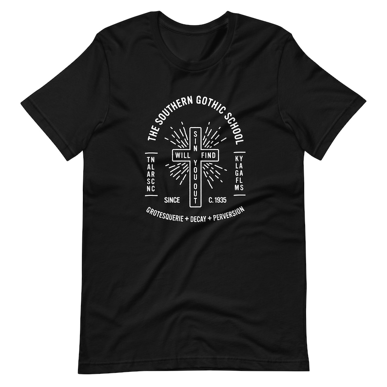 May include: Black t-shirt featuring a white graphic design of a cross with the text "The Southern Gothic School" surrounding it. The cross contains the words "Will Find You Out". The text "Since C. 1935 Grotesquerie + Decay + Perversion" is positioned below the cross.