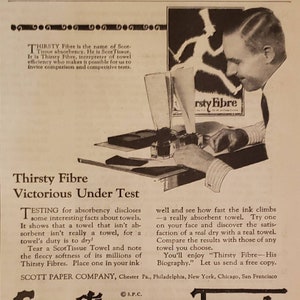 May include: A black and white vintage advertisement for ScotTissue Towels. The ad features a man testing the absorbency of the towels with ink. The text reads "Thirsty Fibre Victorious Under Test" and "ScotTissue Towels".