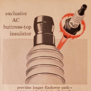 May include: A vintage advertisement for AC Fire-Ring spark plugs. The ad features a close-up of a spark plug with a red umbrella-shaped design around it. The text reads "exclusive AC buttress-top insulator provides longer flashover path - assures quick starts in all weather AC Fire-Ring spark plugs They must be the best!"