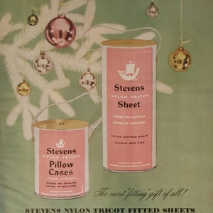May include: A vintage advertisement for Stevens Nylon Tricot fitted sheets. The ad features a pink and white illustration of a Christmas tree with ornaments and two cans of sheets. The text on the cans reads "Stevens Nylon Tricot Sheet" and "Stevens Nylon Tricot Pillow Cases". The ad also includes the text "The most fitting gift of all!" and "Years of luxury...years of wear...minutes of care!"