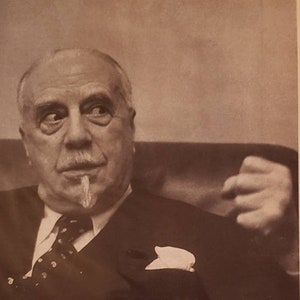 May include: A black and white photo of Sir Thomas Beecham, a British conductor, with the text "The Sound of Genius..." and "Columbia Records" at the top and bottom of the image. The text "Recent Columbia Masterworks "L" Records by Sir Thomas Beecham with the Royal Philharmonic Orchestra include:" is also included in the image.