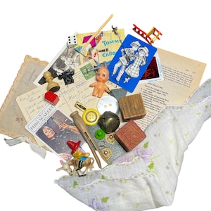 May include: A collection of vintage ephemera and small objects including a white floral handkerchief, a wooden block with the letter R, a small plastic doll, a blue playing card, a Miss Scarlet game card, a metal bell, buttons, and postcards.