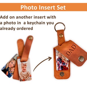 May include: A brown leather keychain with a photo insert. The keychain has a metal ring and a flap that says "DAD". The photo insert is a rectangle with a picture of a couple.