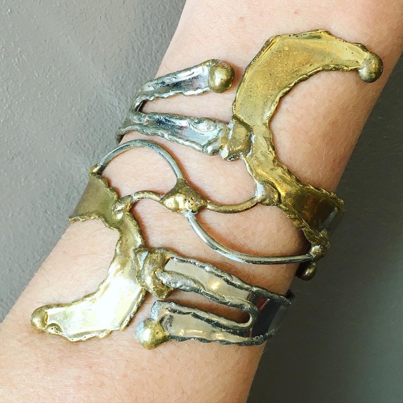 Unique piece and adjustable to all wrists Like an abstract sculpture Open cuff bracelet in goldsilver metal