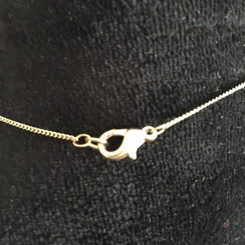 Neck knot consisting of a very thin chain and a brass knot pendant An adorable fantasy!