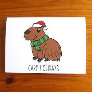 Jeu de mots Capybara Carte de Noël « Capy Holidays » A6 – Cadeau pour amoureux des capybaras, Capybara de Noël, carte d'animal original, carte de père Noël secret
