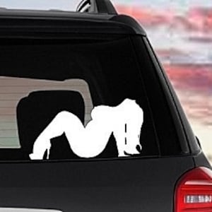 May include: White vinyl decal of a woman in a suggestive pose. The decal is designed for application to a car window.