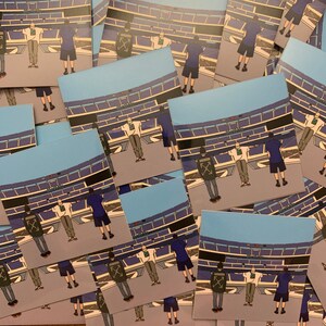 May include: A collection of stickers featuring a cartoon illustration of a stadium with people standing in front of it. The stickers are printed on white paper and have a glossy finish.