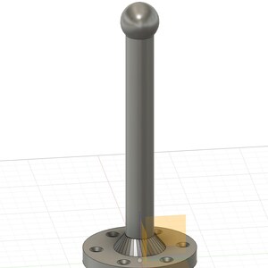 May include: A silver metal rod with a round ball on top and a circular base with six holes. The rod is attached to the base with a cone-shaped piece.