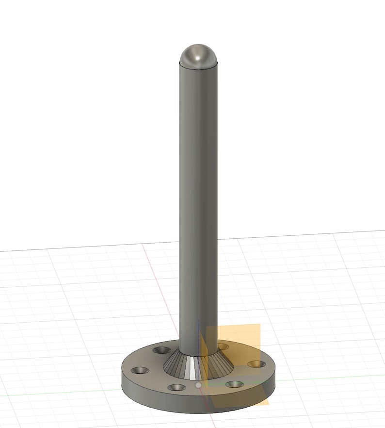 May include: A silver metal post with a rounded top and a base with a flange and six holes. The post is standing on a gridded surface.